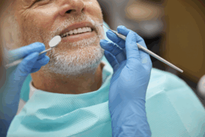 Older man visits the dentist due to dental pain