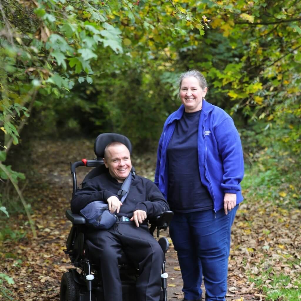 Christies Care Client, Wes and his Carer, Tracey walking together in Saxmundham Park.